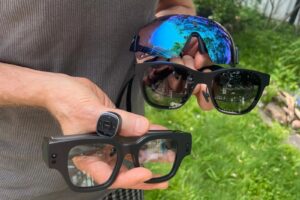 Man Holding AR Glasses from Different Brands